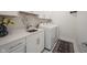 Well-lit laundry room featuring a sink and modern washer and dryer at 1580 Mairn Ave, Carmel, IN 46032