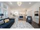 Bright open-concept living space features hardwood floors, stylish furnishings, and seamless flow to the modern kitchen at 1580 Mairn Ave, Carmel, IN 46032