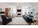 Spacious living room featuring a stylish fireplace, hardwood floors, and ample seating at 1580 Mairn Ave, Carmel, IN 46032