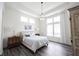 Bright main bedroom suite with tray ceilings, stylish lighting, and an abundance of natural light from multiple windows at 1580 Mairn Ave, Carmel, IN 46032