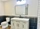 Bathroom with a modern vanity, mirror, tile accents and toilet at 15841 E 265 N, Columbus, IN 47203