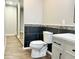 Bathroom with wood flooring, tile accents, a modern toilet and vanity at 15841 E 265 N, Columbus, IN 47203