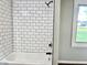 Bathroom showcasing a shower-tub combo with white subway tile and black fixtures at 15841 E 265 N, Columbus, IN 47203