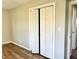 Bright bedroom with bi-fold closet and wood-look flooring at 15841 E 265 N, Columbus, IN 47203