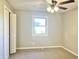Cozy bedroom with carpet flooring, ceiling fan, and a bright window view at 15841 E 265 N, Columbus, IN 47203
