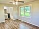 Bedroom with hardwood floors, connecting to bathroom with tub and vanity at 15841 E 265 N, Columbus, IN 47203