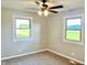 Neutral bedroom offers natural light from dual windows, plus a ceiling fan at 15841 E 265 N, Columbus, IN 47203