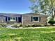 A well-maintained brick home with a curved walkway and lush landscaping, offering curb appeal at 15841 E 265 N, Columbus, IN 47203