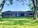 Charming brick home with mature trees and a well-manicured lawn under a bright sky at 15841 E 265 N, Columbus, IN 47203