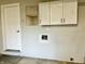 Garage storage with utility door and built in cabinets at 15841 E 265 N, Columbus, IN 47203