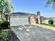 View of a home's side showcasing the garage, driveway, and some lawn at 15841 E 265 N, Columbus, IN 47203