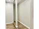 Hallway featuring wood floors, neutral walls, and architectural beam accents at 15841 E 265 N, Columbus, IN 47203