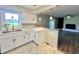 Renovated kitchen featuring white cabinets, new countertops, and view to living area at 15841 E 265 N, Columbus, IN 47203