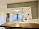 Modern kitchen with breakfast bar, sleek lighting, stainless steel sink and updated cabinets at 15841 E 265 N, Columbus, IN 47203
