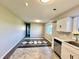 Eat-in kitchen featuring updated cabinets, stainless steel appliances, and new flooring at 15841 E 265 N, Columbus, IN 47203