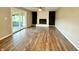 Spacious living room with fireplace, ceiling fan, and sliding glass door to outdoor space at 15841 E 265 N, Columbus, IN 47203