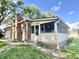 Exterior view of a brick home with a screened-in porch and chimney at 15841 E 265 N, Columbus, IN 47203