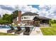 Luxurious backyard with a swimming pool, cabana, outdoor kitchen, manicured lawn, and elegant brick house at 15920 Oak Park Ct, Westfield, IN 46074