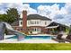 Stunning backyard with a large pool, slide, cabana, outdoor kitchen, fountains, and green lawn at 15920 Oak Park Ct, Westfield, IN 46074