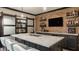 Finished basement wet bar with brick wall, gray cabinetry, and shelving, perfect for entertaining guests and Gathering at 15920 Oak Park Ct, Westfield, IN 46074