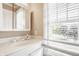 Bathroom with a vanity and sink next to a bright window with a view at 15920 Oak Park Ct, Westfield, IN 46074