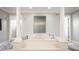 Bright bathroom features a large soaking tub, columns, and light gray walls at 15920 Oak Park Ct, Westfield, IN 46074