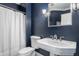 Clean bathroom featuring classic fixtures, a pedestal sink, and a neatly tucked shower curtain at 15920 Oak Park Ct, Westfield, IN 46074