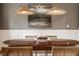 Close-up of dining room table and chairs with a modern centerpiece under woven pendant lights at 15920 Oak Park Ct, Westfield, IN 46074
