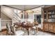 Cozy dining area with a stylish hutch, view into the office, and a staircase nearby at 15920 Oak Park Ct, Westfield, IN 46074