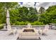 Inviting outdoor firepit area with white chairs and a lush green backdrop, perfect for entertaining at 15920 Oak Park Ct, Westfield, IN 46074