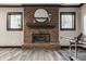 Finished basement fireplace, with brick surround and mantle, flanked by windows, next to game room at 15920 Oak Park Ct, Westfield, IN 46074