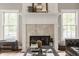 Elegant fireplace with a white mantel, decorative accents, and natural light streaming through the windows at 15920 Oak Park Ct, Westfield, IN 46074