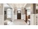 Inviting foyer with elegant tile flooring, a charming arched doorway, and beautiful molding at 15920 Oak Park Ct, Westfield, IN 46074