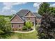 Elegant brick home featuring a manicured lawn and beautiful landscaping at 15920 Oak Park Ct, Westfield, IN 46074