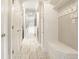 Bright hallway with white walls, tile floors, storage and natural light creating a welcoming and functional space at 15920 Oak Park Ct, Westfield, IN 46074