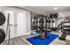 Finished basement home gym with mirrored wall, free weights, and treadmill for staying active and healthy at 15920 Oak Park Ct, Westfield, IN 46074