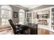 Bright home office with arched windows leading into a dining area through glass-paned doors at 15920 Oak Park Ct, Westfield, IN 46074