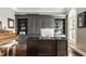 Inviting home office with custom shelving, sleek gray built-ins and a light filled window at 15920 Oak Park Ct, Westfield, IN 46074