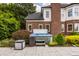 Relaxing hot tub nestled in a beautifully landscaped backyard with a brick house backdrop at 15920 Oak Park Ct, Westfield, IN 46074