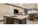 Finished basement wet bar island with stone countertop, sink, seating, and stainless steel dishwasher for convenience at 15920 Oak Park Ct, Westfield, IN 46074