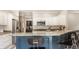 Modern kitchen with granite countertop, stainless steel appliances, bar seating, and white cabinets at 15920 Oak Park Ct, Westfield, IN 46074