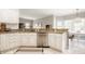 Bright kitchen with stainless steel appliances, granite counters, white cabinets, and tiled backsplash at 15920 Oak Park Ct, Westfield, IN 46074