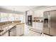 Spacious kitchen featuring stainless steel appliances, granite countertops, and white cabinets at 15920 Oak Park Ct, Westfield, IN 46074
