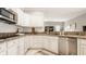 Well-lit kitchen with white cabinets, granite countertops, stainless steel appliances and tiled backsplash at 15920 Oak Park Ct, Westfield, IN 46074