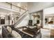 Open-concept living room with a grand staircase, comfortable seating, and hardwood floors at 15920 Oak Park Ct, Westfield, IN 46074