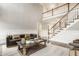 Spacious living room with a staircase, dark leather sofa, and stylish decor at 15920 Oak Park Ct, Westfield, IN 46074