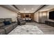 Finished basement living room with hardwood floors, bar area, recliners, and entertainment area for ultimate relaxation at 15920 Oak Park Ct, Westfield, IN 46074