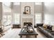 Bright living room featuring a fireplace, large windows, and comfortable seating at 15920 Oak Park Ct, Westfield, IN 46074