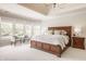 Bright main bedroom with a large bed, sitting area, and many windows to enjoy the scenery at 15920 Oak Park Ct, Westfield, IN 46074
