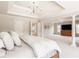 Elegant main bedroom showcasing tray ceilings, columns, and a glimpse of the en suite bathroom at 15920 Oak Park Ct, Westfield, IN 46074
